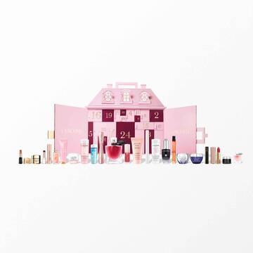 A pink Lancome advent calendar shaped like a townhouse with beauty products displayed in front.