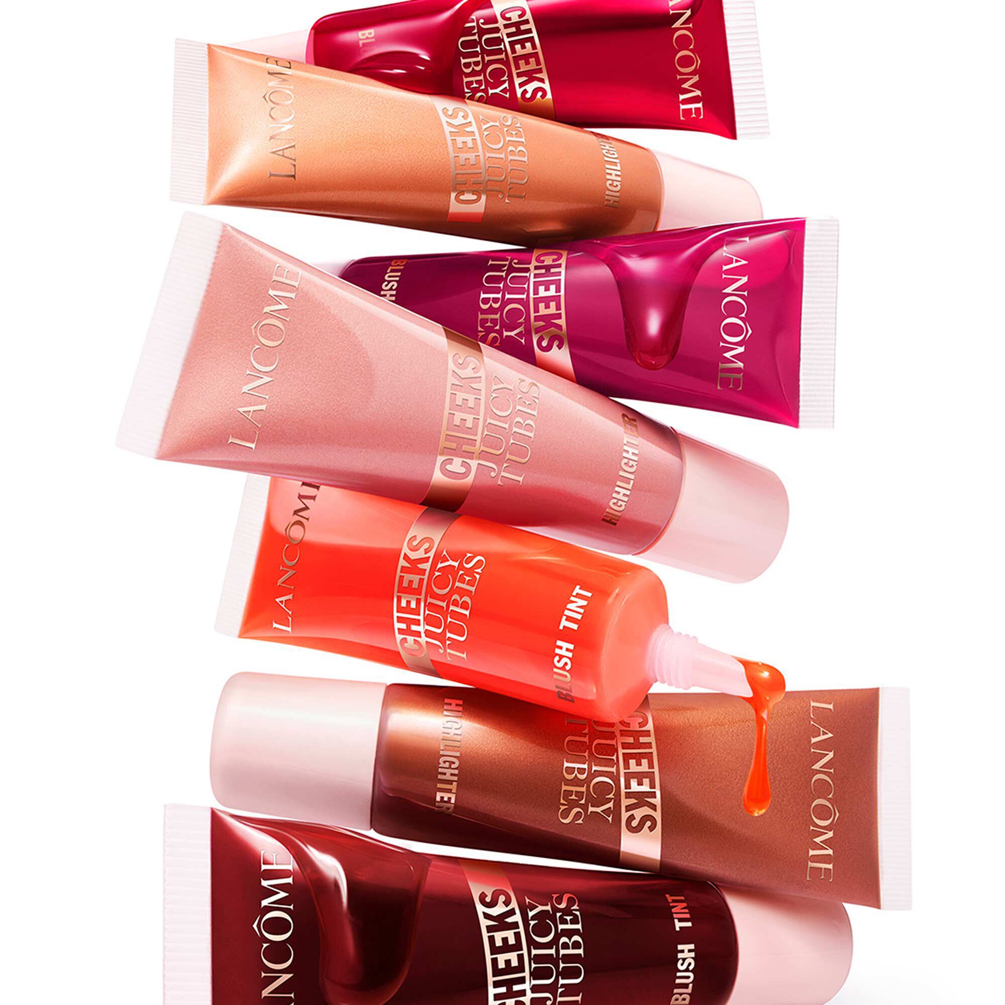 A stack of Juicy Tubes Cheeks Highlighter in various shades.