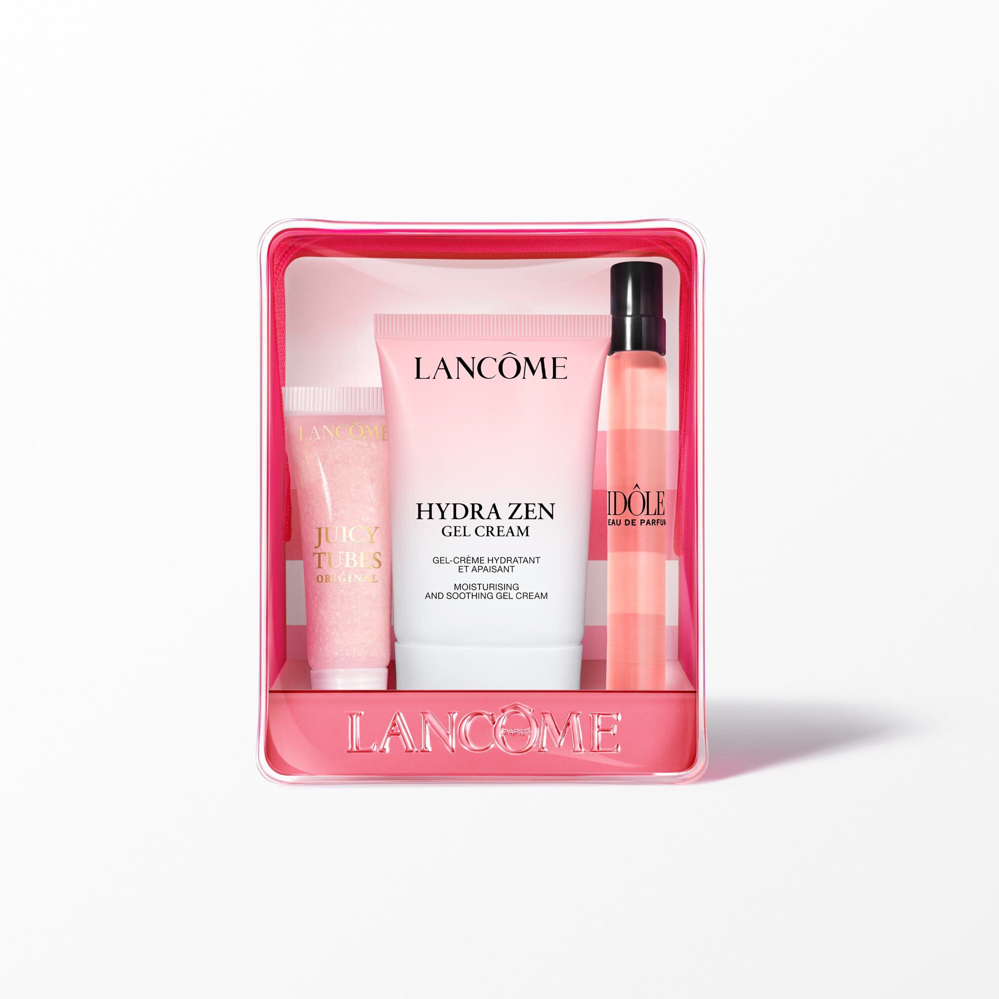 The Lancome gift set components with the pouch standing behind the cream, lip gloss, and perfume.